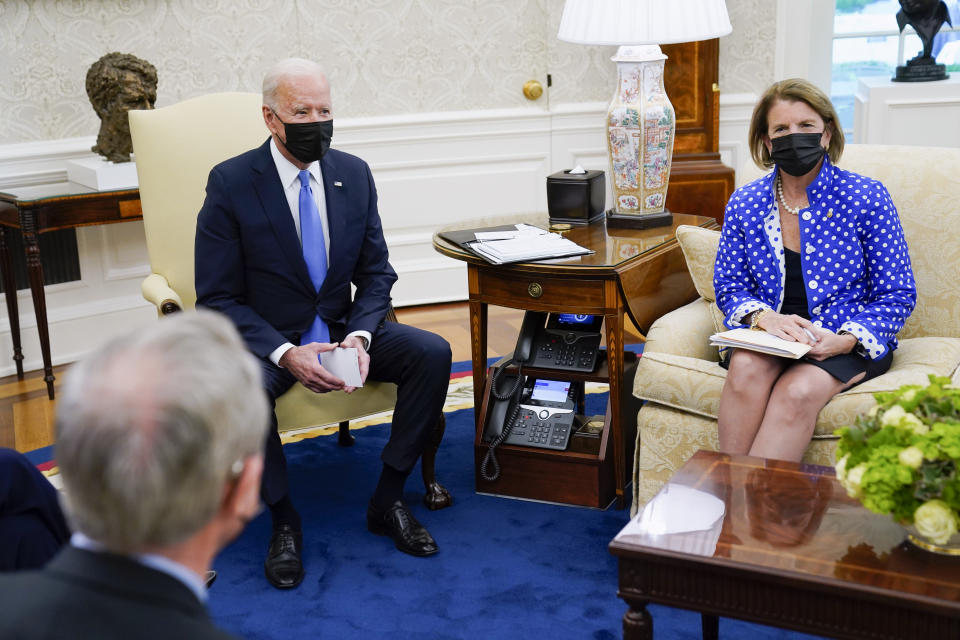 President Joe Biden speaks during a meeting in the Oval Office of the White House, Thursday, May 13, 2021, in Washington. Sen. Shelley Moore Capito, R-W.Va., right, and Sen. Mike Crapo, R-Idaho listen. (AP Photo/Evan Vucci)