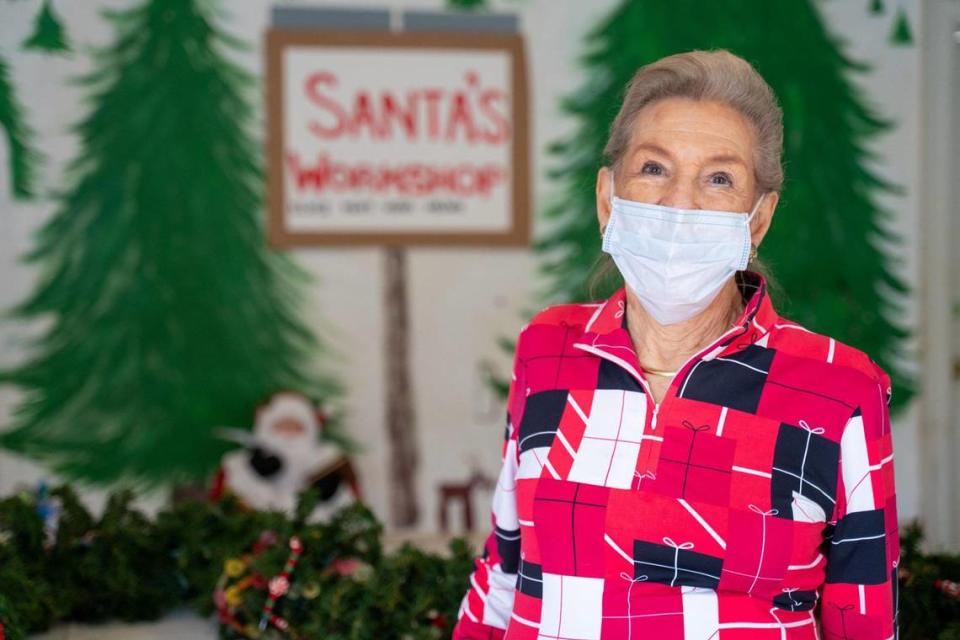 Gwin Dalton stands in the garage at her house in the Wendover-Sedgewood neighborhood. Her daughter, Dede Caughman, created a massive mural inside for a socially distant to-go Christmas.