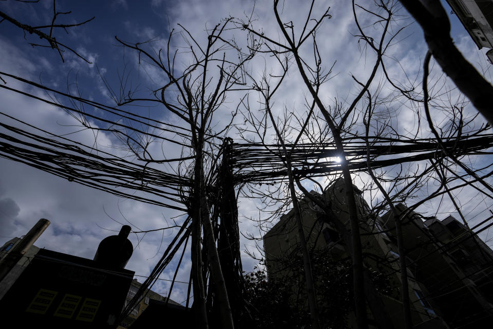 Dozens of electric cables connect homes and businesses to privately-owned diesel generators, in Beirut, Lebanon, Friday, March 4, 2022. Private generators are ubiquitous in parts of the Middle East, spewing hazardous fumes into homes and business across the country, almost 24 hours a day. As the world looks for renewable energy to tackle climate change, Lebanon, Iraq, Gaza and elsewhere rely on diesel-powered private generators just to keep the lights on. The reason is state failure: In multiple countries, governments can’t maintain a functioning central power network, whether because of war, conflict or mismanagement and corruption. (AP Photo/Hassan Ammar)