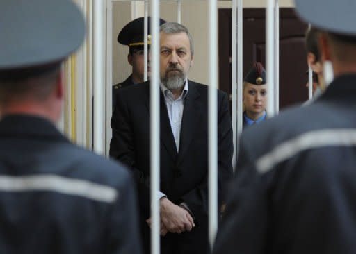 Belarus opposition leader Andrei Sannikov stands in the defendant's cage during his trial in Minsk. Belarus is facing an international outcry after jailing Sannikov, the main rival of autocratic President Alexander Lukashenko, for five years in a process denounced by the opposition as a political show trial