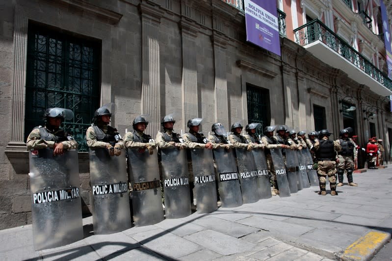 Military police officers keep watch outside the old presidential palace in La Paz