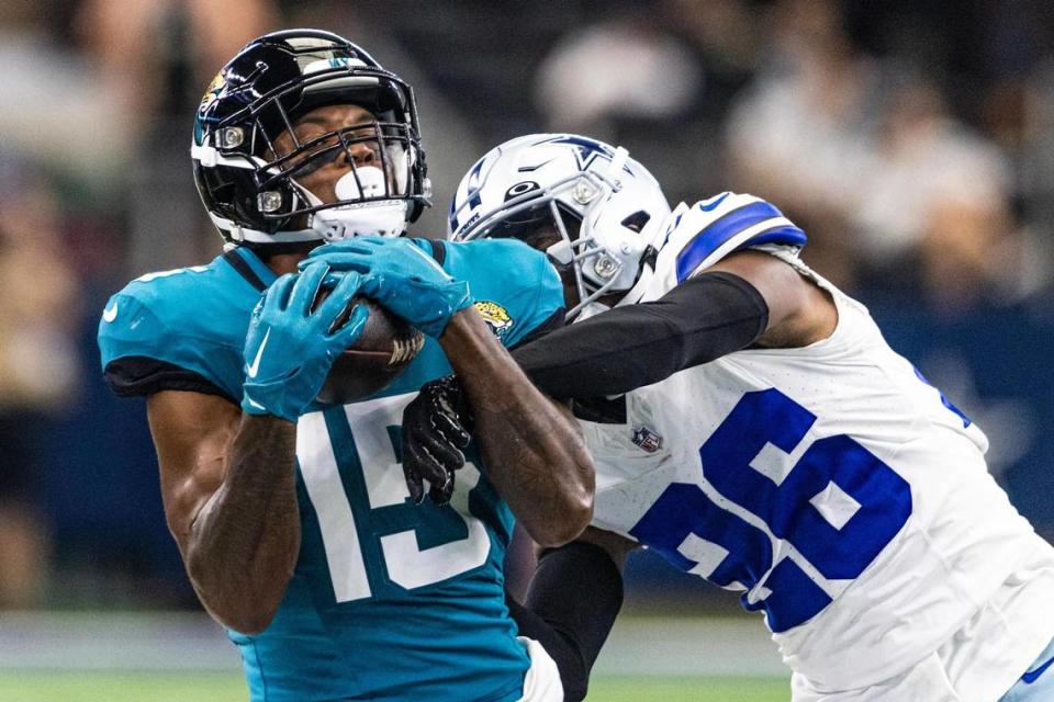 Jacksonville Jaguars wide receiver Tim Jones (15) goes for a catch over Dallas Cowboys defender DaRon Bland (15) during the first preseason game between the Dallas Cowboys and Jacksonville Jaguars at AT&T Stadium in Arlington, Texas on Saturday, Aug. 12, 2023. Chris Torres/ctorres@star-telegram.com