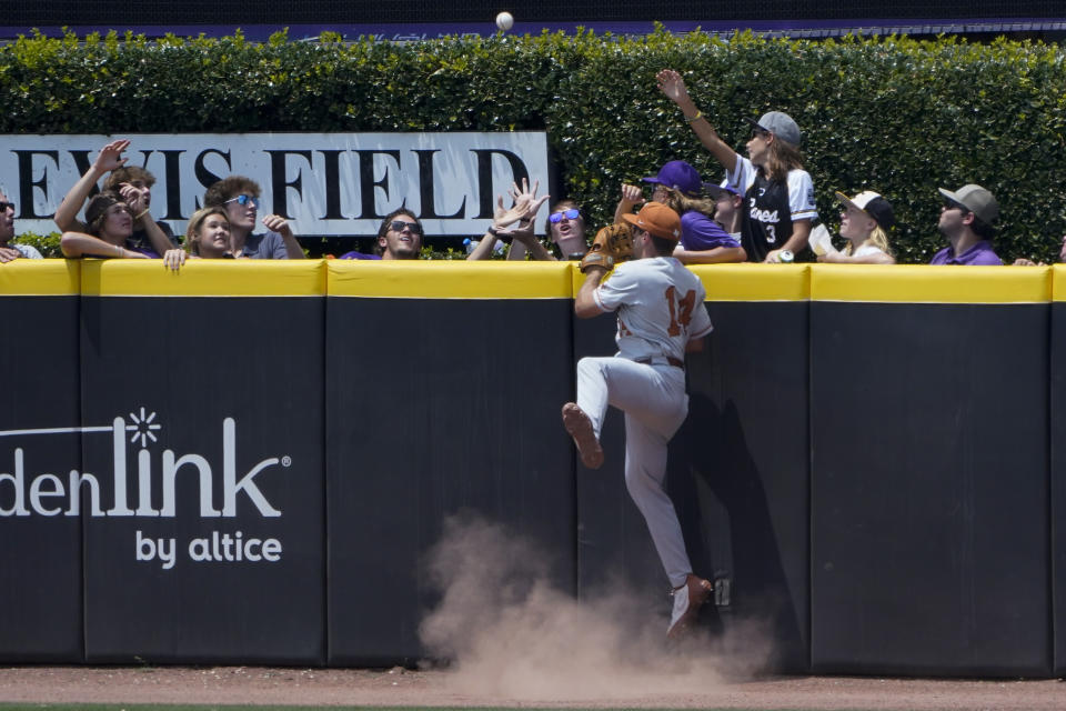 Texas right fielder Murphy Stehly watches a home run by East Carolina's Bryson Worrell during the fifth inning of an NCAA college super regional baseball game Friday, June 10, 2022, in Greenville, N.C. (AP Photo/Chris Carlson)