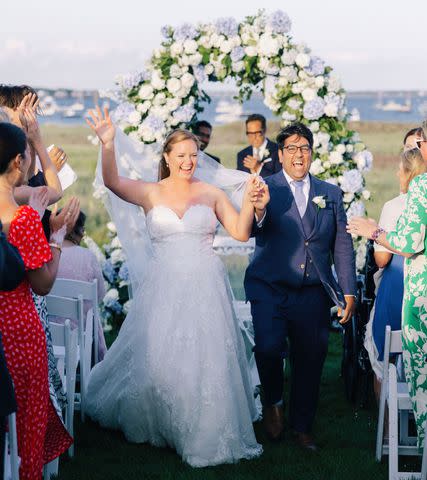 <p>Alex Gordias</p> Sarah Kennedy and Jam Sulahry walk back down the aisle after tying the knot.