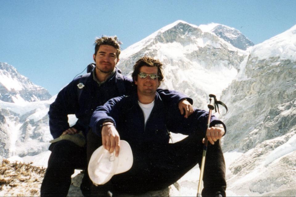 Michael Matthews (left) with friend Jamie Everett in front of the summit of Everest in 1999 (PA)