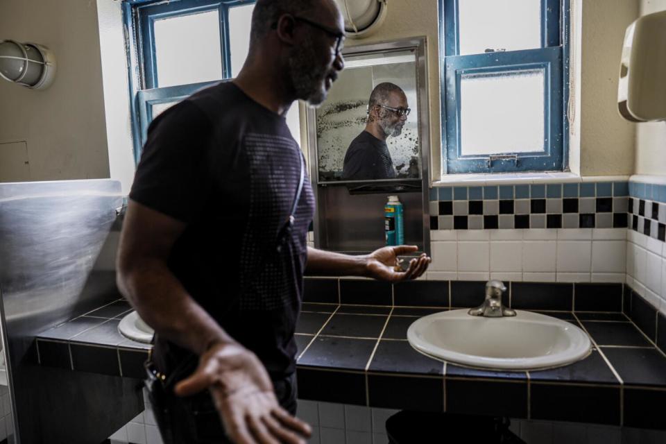 Micah Ray, inside a community bathroom in the Haskell Hotel, where he lives.