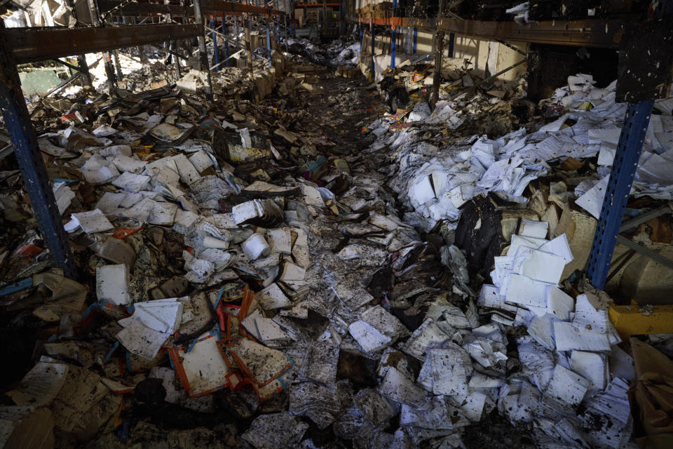 Burnt books are seen in a damaged workshop of Ukraine's largest printing house ruined in Thursday deadly Russian missile attack that killed seven civilians in Kharkiv, Ukraine, Friday, May 24, 2024. (Ukrainian Presidential Press Office via AP)