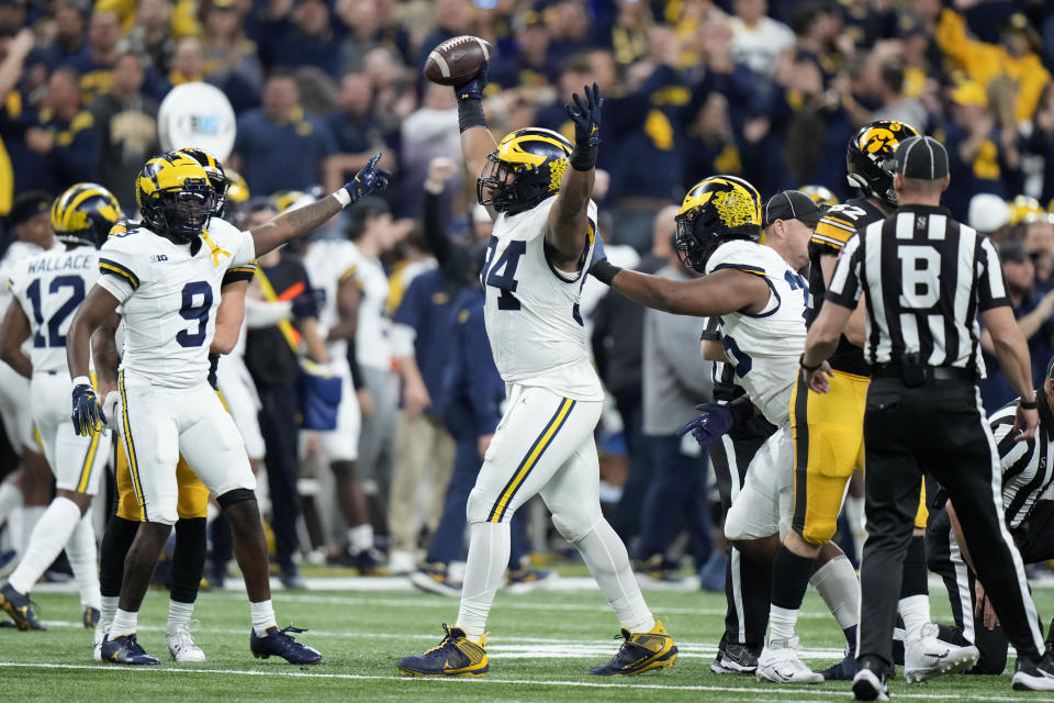 Michigan defensive lineman Kris Jenkins (94) celebrates after recovering a fumble during the first half of the Big Ten championship NCAA college football game against Iowa, Saturday, Dec. 2, 2023, in Indianapolis. (AP Photo/AJ Mast)