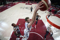 Italy's Nicolo Melli dunks the ball ahead of France's Guerschon Yabusele, left, during a men's basketball quarterfinal round game at the 2020 Summer Olympics, Tuesday, Aug. 3, 2021, in Saitama, Japan. (AP Photo/Charlie Neibergall, Pool)