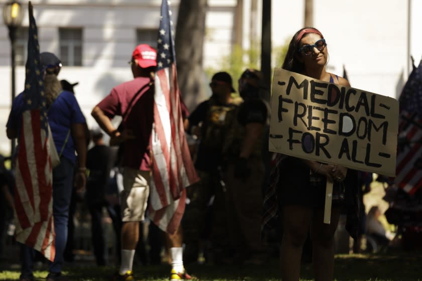 LOS ANGELES, CA - SEPTEMBER 18, 2021 - - Dozens of anti-vax protesters rally in front of City Hall in Los Angeles on September 18, 2021. An anti-vaxxer was stabbed and a reporter was sent to the hospital with a head injury at last month's rally at City Hall. (Genaro Molina / Los Angeles Times)