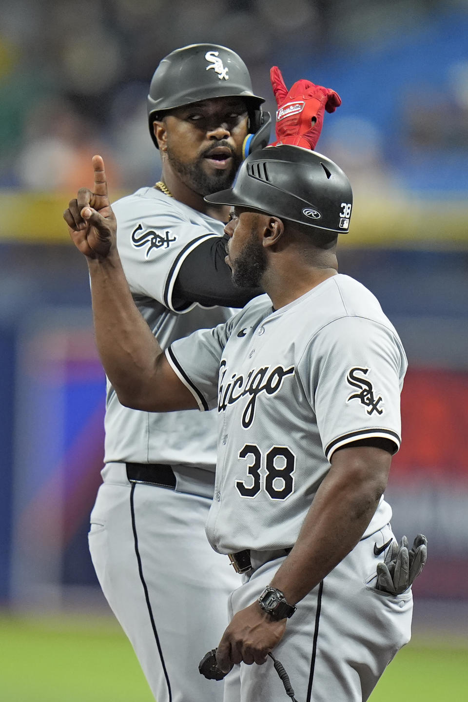 Chicago White Sox's Eloy Jimenez celebrates with first base coach/outfield coach Jason Bourgeois (38) after hitting a single off Tampa Bay Rays starting pitcher Aaron Civale during the fourth inning of a baseball game Wednesday, May 8, 2024, in St. Petersburg, Fla. (AP Photo/Chris O'Meara)
