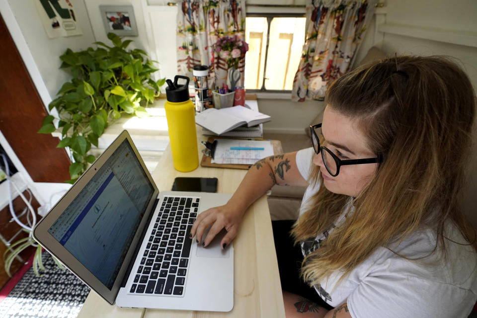 FILE - In this Wednesday, Sept. 2, 2020 file photo, Kelly Mack works on her laptop to teach remotely from her early 1940s vintage camper/trailer in her backyard at home in Evanston, Ill. Across the U.S., the pandemic has forced students to attend virtual school to prevent spread of the coronavirus. But the more we rely on technology, the bigger the consequences when gadgets or internet service let us down. (AP Photo/Nam Y. Huh, File)