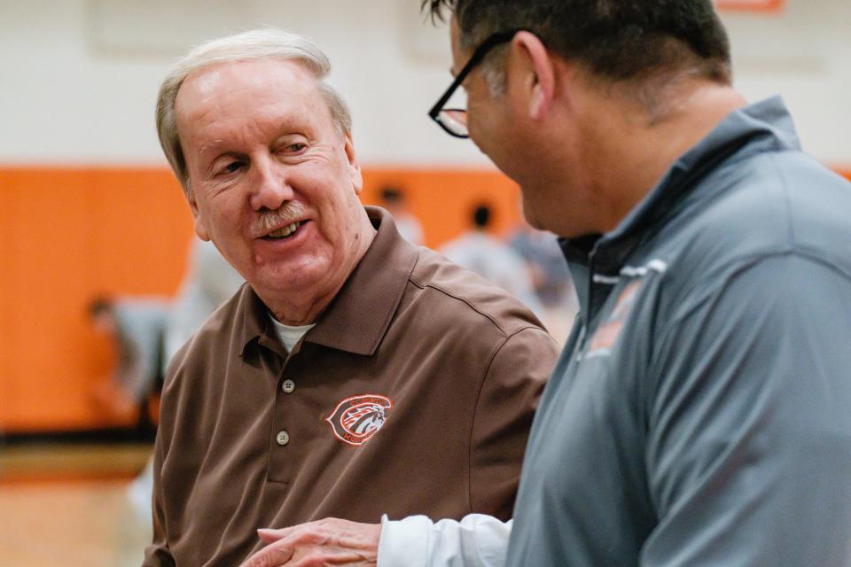 Jim Carrothers, left, chats with Claymont boys' basketball head coach Gary Watkins before tipoff against Connotton Valley, Friday, Dec. 2. Carrothers has been running the clock at Claymont for 50 years.