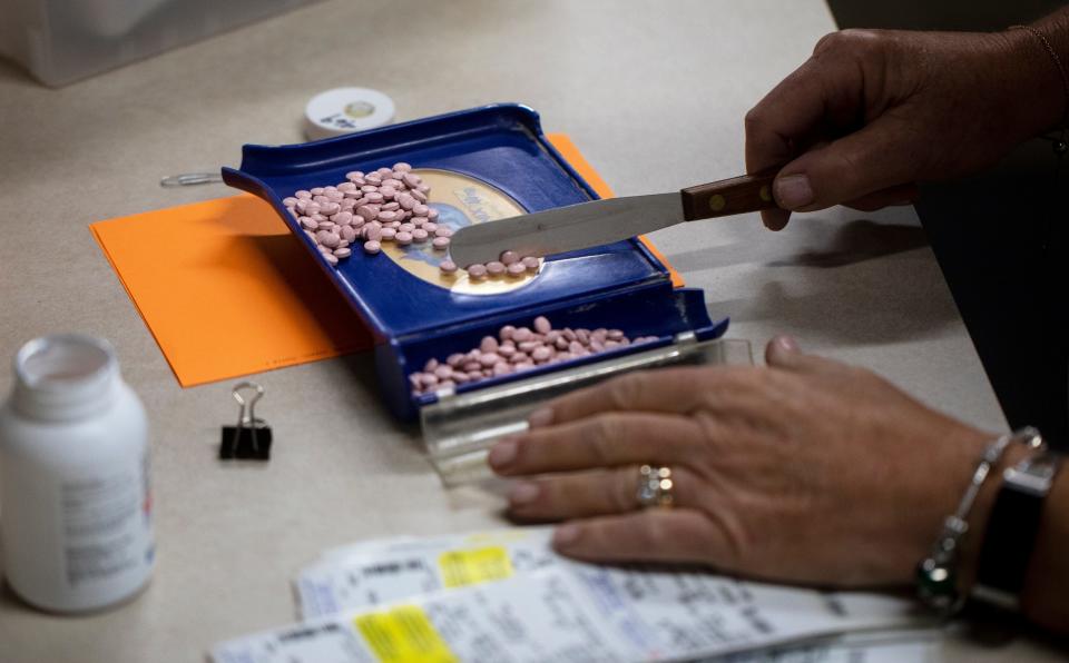 Carol Foltz prepares prescription medications at Faith Community Pharmacy in Newport on June 6. She's volunteered with the pharmacy for 20 years. Its move from Florence is due to a growing enrollment of people who need free prescription medication.