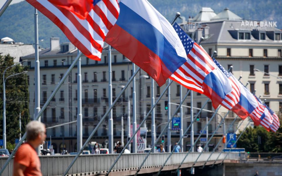 Geneva is preparing to host the summit between Russia and the US on Wednesday by putting up flags around the town - Stefan Wermuth/Bloomberg