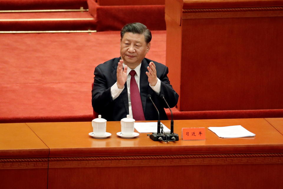 Chinese President Xi Jinping applauds at a meeting commending role models of the Beijing 2022 Olympic and Paralympic Winter Games, at the Great Hall of the People in Beijing, China April 8, 2022. REUTERS/Florence Lo