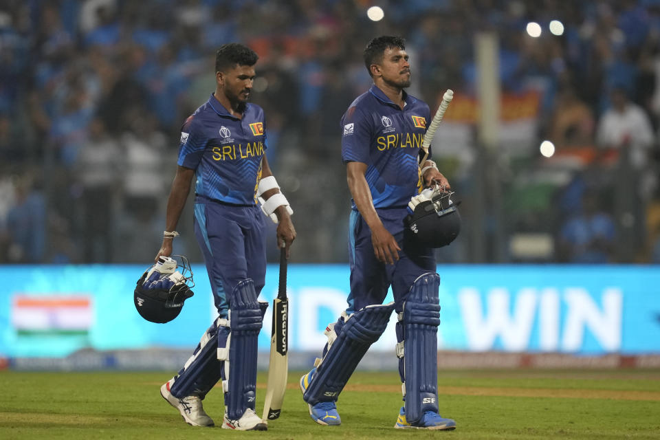 Sri Lanka's Dilshan Madushanka, left and Maheesh Theekshana walks off the field after losing the ICC Men's Cricket World Cup match against India in Mumbai, India, Thursday, Nov. 2, 2023.(AP Photo/Rafiq Maqbool)