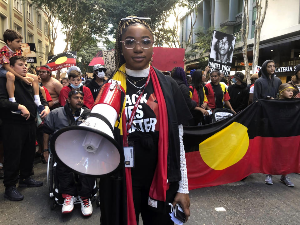 A rally organizer leads a march from King George Square to South Brisbane at a Black Lives Matter protest on Saturday, June 6, 2020, to support the movement over the death of George Floyd in the U.S. and the deaths of Aboriginal and Torres Strait Islands people in custody in Australia. Black Lives Matter protests across Australia proceeded mostly peacefully Saturday as thousands of demonstrators in state capitals honored the memory of Floyd and protested the deaths of indigenous Australians in custody. (AP Photo/John Pye)