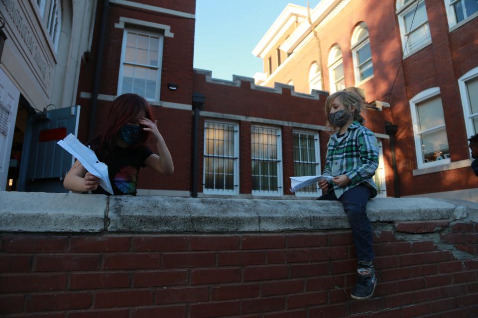 Eli Fidler, right, sits on a wall with Audrey Silberg following an after school program at Susie King Taylor Community School.