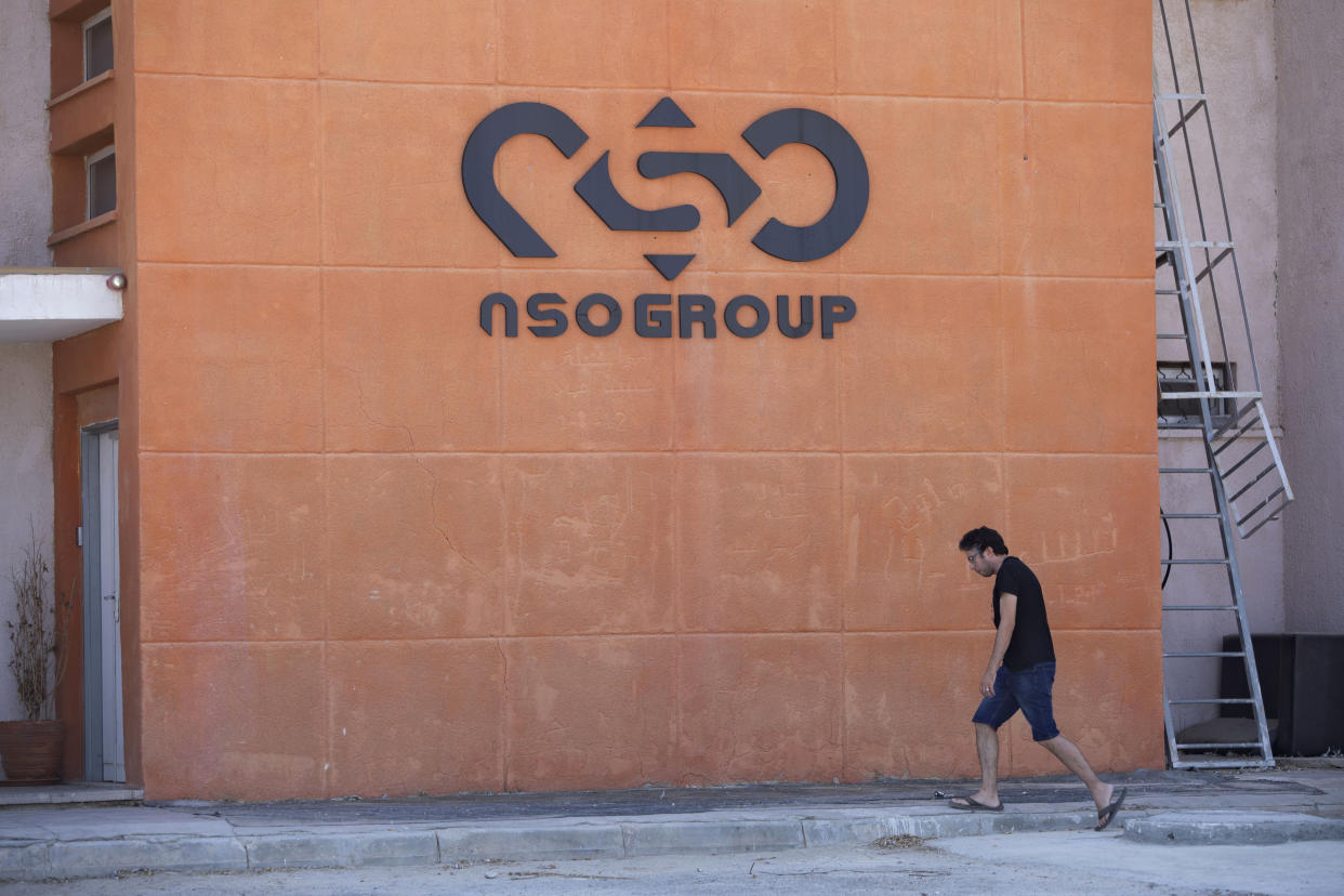 FILE - A logo adorns a wall on a branch of the Israeli NSO Group company, near the southern Israeli town of Sapir, Aug. 24, 2021. Tech giant Apple announced Tuesday, Nov. 23, that it is suing Israel’s NSO Group, seeking to block the world’s most infamous hacker-for-hire company from breaking into Apple's products, like the iPhone. (AP Photo/Sebastian Scheiner, File)