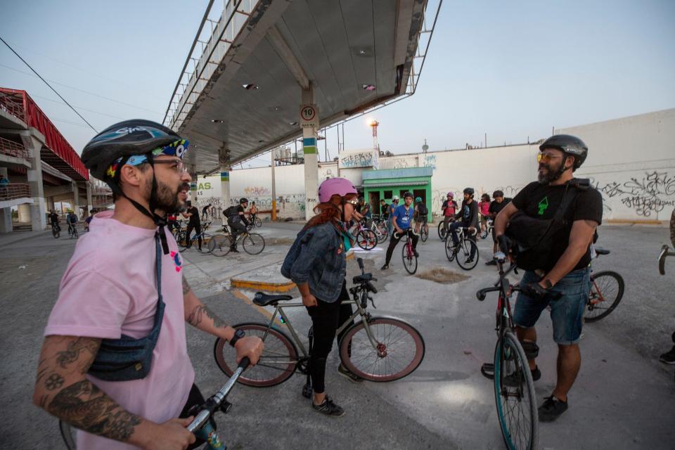 Bastards Border Cycling Club rides on a warm night in April 2022. Jorge Castillo, right, founded the group in 2021 with several friends.