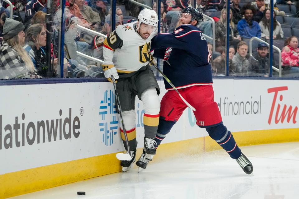 Blue Jackets defenseman Vladislav Gavrikov hits Vegas forward Chandler Stephenson.