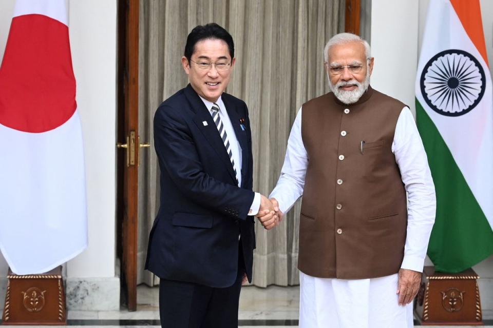 Japan’s Prime Minister Fumio Kishida (left) shakes hands with his Indian counterpart Narendra Modi before their meeting at the Hyderabad House in New Delhi on 20 March  (AFP via Getty Images)
