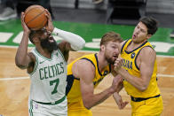 Boston Celtics guard Jaylen Brown (7) shoots against Indiana Pacers forward Domantas Sabonis, middle, and forward Doug McDermott, right, in the second half of an NBA basketball game, Friday, Feb. 26, 2021, in Boston. (AP Photo/Elise Amendola)