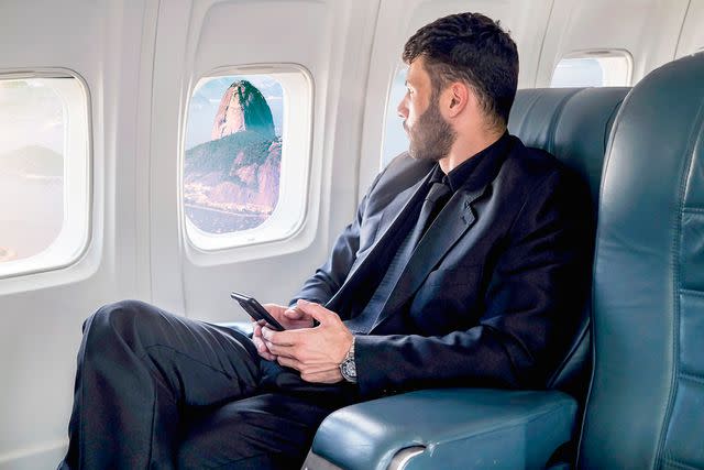 <p>wsfurlan/Getty</p> A man in first class on an airplane (stock image)