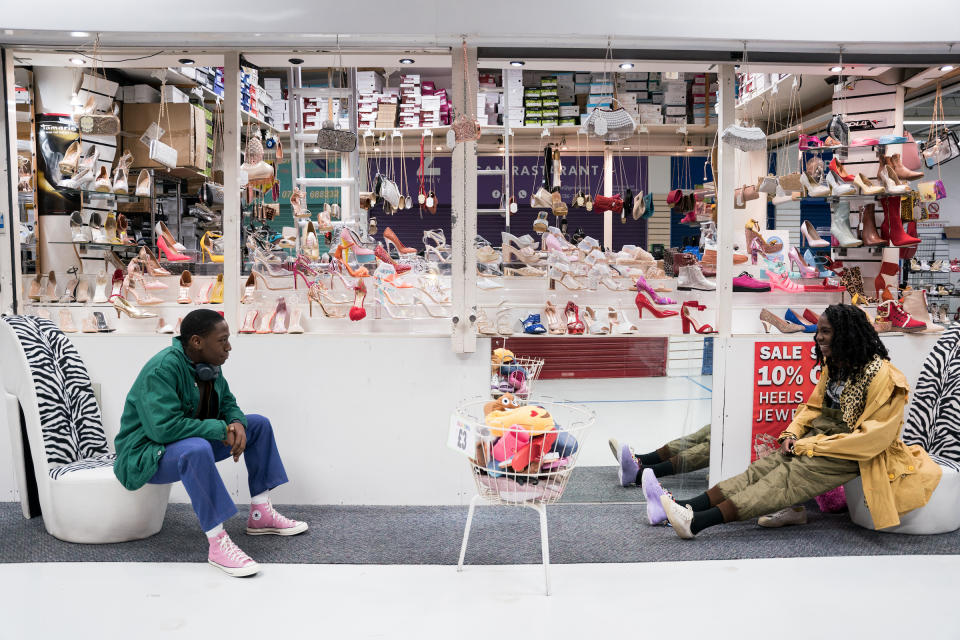 Inside Rye Lane Market, Dom (David Jonsson) votes on a pair of shoes Yas (Vivian Oparah) tries on.<span class="copyright">Chris Harris—20th Century Studios</span>