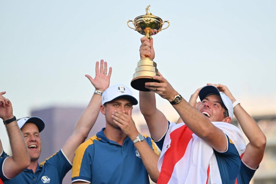 Rory McIlroy holds up the trophy (AFP via Getty Images)