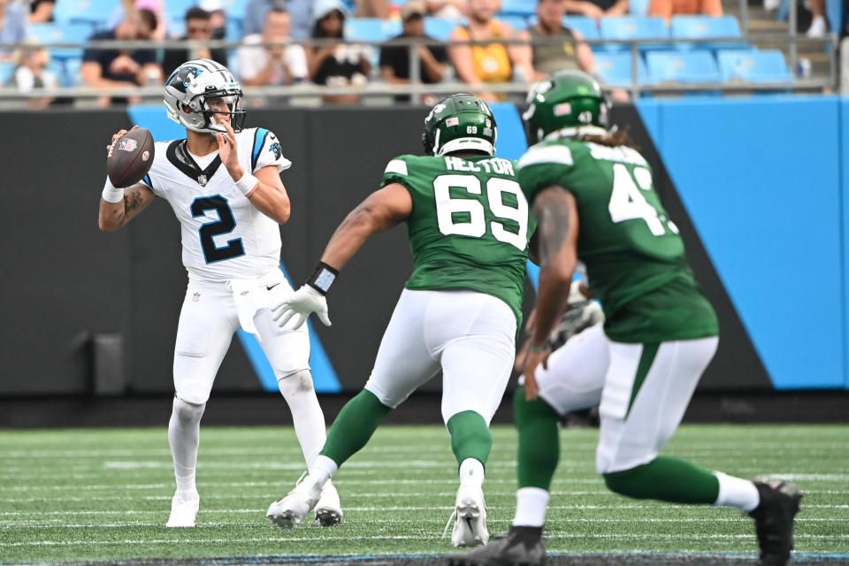 Aug 12, 2023; Charlotte, North Carolina, USA; Carolina Panthers quarterback <a class="link " href="https://sports.yahoo.com/nfl/players/34050" data-i13n="sec:content-canvas;subsec:anchor_text;elm:context_link" data-ylk="slk:Matt Corral;sec:content-canvas;subsec:anchor_text;elm:context_link;itc:0">Matt Corral</a> (2) looks to pass as New York Jets defensive tackle Bruce Hector (69) defends in the third quarter at Bank of America Stadium. Mandatory Credit: Bob Donnan-USA TODAY Sports