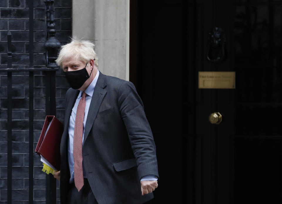 Britain's Prime Minister Boris Johnson leaves 10 Downing Street for the House of Commons to attend his weekly Prime Minister's Questions in London, Wednesday, Sept. 30, 2020. (AP Photo/Alastair Grant)