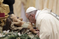 <p>Pope Francis kisses a statue of the Divine Infant as he arrives to celebrate an Epiphany Mass in St. Peter’s Basilica at the Vatican, Saturday, Jan. 6, 2018. (Photo: Andrew Medichini/AP) </p>