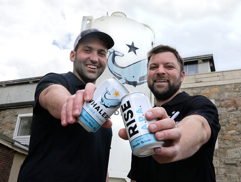 Josh Dunlap and Wes Staschke, co-owners of Whalers Brewing in South Kingstown, raise some cans of Rise APA.