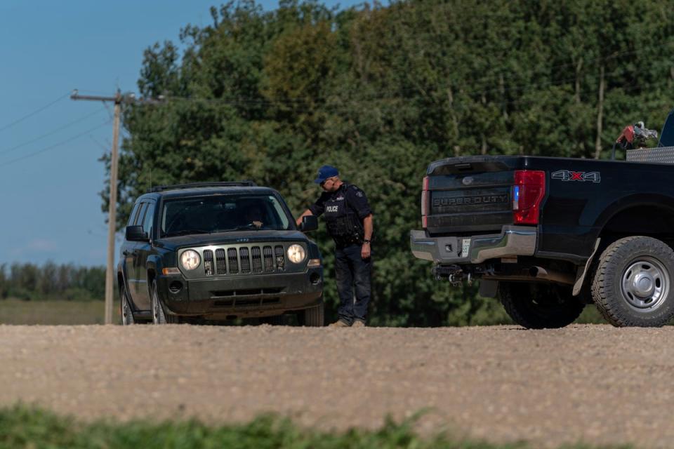 An RCMP officer at a police road block in James Smith Cree Nation, Saskatchewan (Heywood Yu/The Canadian Press via AP) (AP)