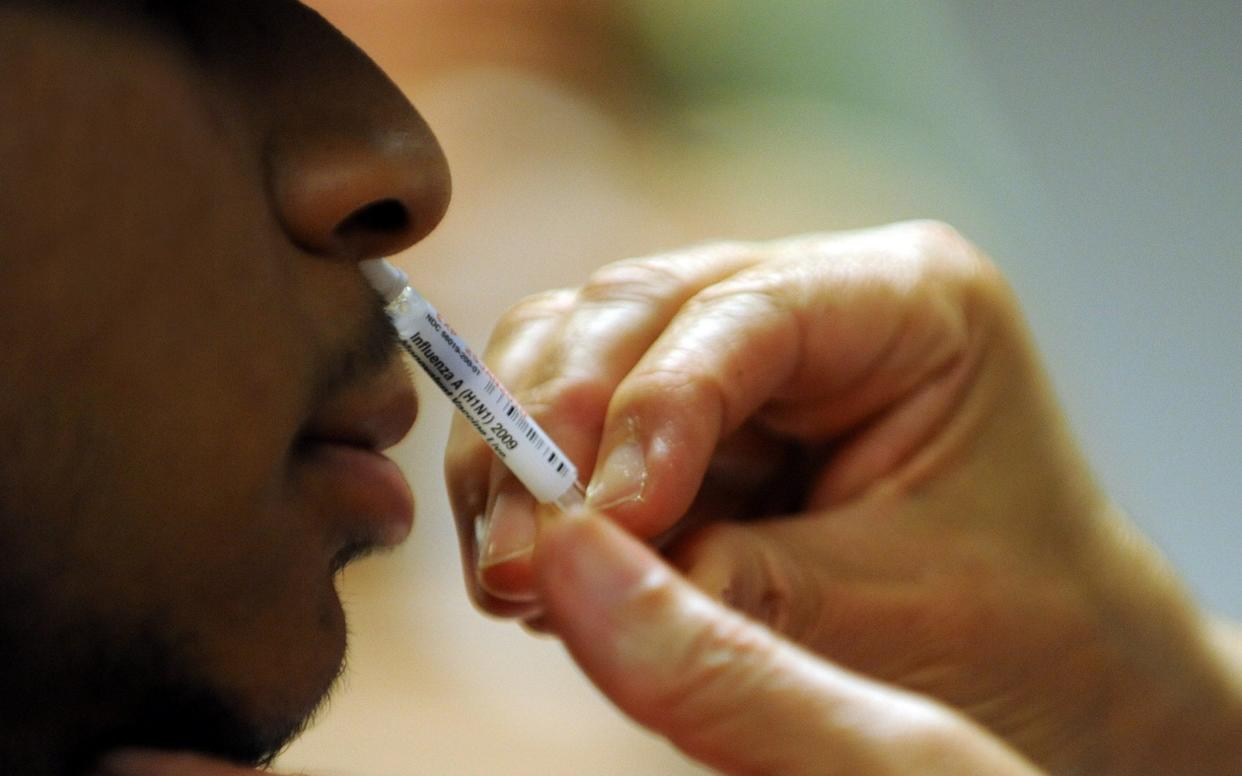 A patient receiving a nasal spray - Tim Sloan/AFP