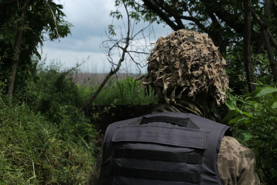 A Ukrainian soldier of the 110th Territorial Defense Brigade looks out towards no man's land from a front-line position in southeastern Ukraine on May 25, 2023. (Photo: Francis Farrell/The Kyiv Independent)