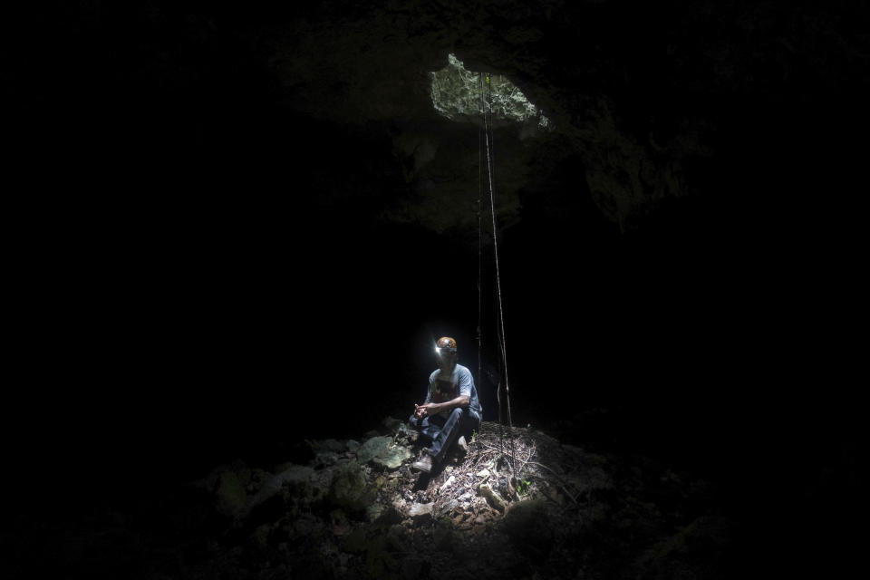 Raul Padilla, member of the Jaguar Wildlife Center which works to protect jaguars, poses for a portrait inside a miles-long cave system known as "Garra de Jaguar," or The Paw of the Jaguar," located underneath the planned route of the Maya Train in Playa del Carmen, Quintana Roo state, Mexico, Thursday, Aug. 4, 2022. Mexican President Andres Manuel Lopez Obrador wants to finish the entire train in 16 months by filling the caves with cement or sinking concrete columns through the caverns – the only places that allowed humans to survive in this area. (AP Photo/Eduardo Verdugo)