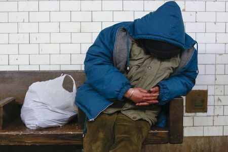 A man sleeps on a seat at the Borough Hall subway station in the Brooklyn borough of New York February 10, 2015. REUTERS/Shannon Stapleton