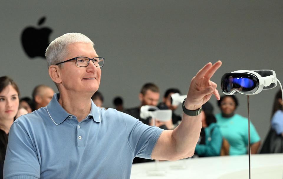 Apple CEO Tim Cook speaks with members of the media next to Apple's new Vision Pro virtual reality headset, during Apple's Worldwide Developers Conference (WWDC) at the Apple Park campus in Cupertino, California, on June 5, 2023. Apple on Monday unveiled its first-ever virtual reality headset challenging Facebook-owner Meta in a market that has yet to tempt users beyond videogamers and tech geeks. The release was the most significant product launch by the iconic iPhone maker since it unveiled the Apple Watch in 2015. (Photo by Josh Edelson / AFP) (Photo by JOSH EDELSON/AFP via Getty Images)