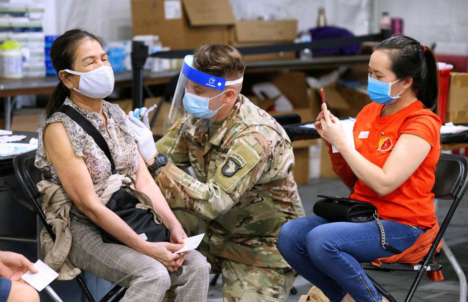 A mother and daughter receive COVID-19 vaccines as Floridians continue to receive shots at the FEMA-supported Vaccination Site at Valencia College West Campus in Orlando, Florida.