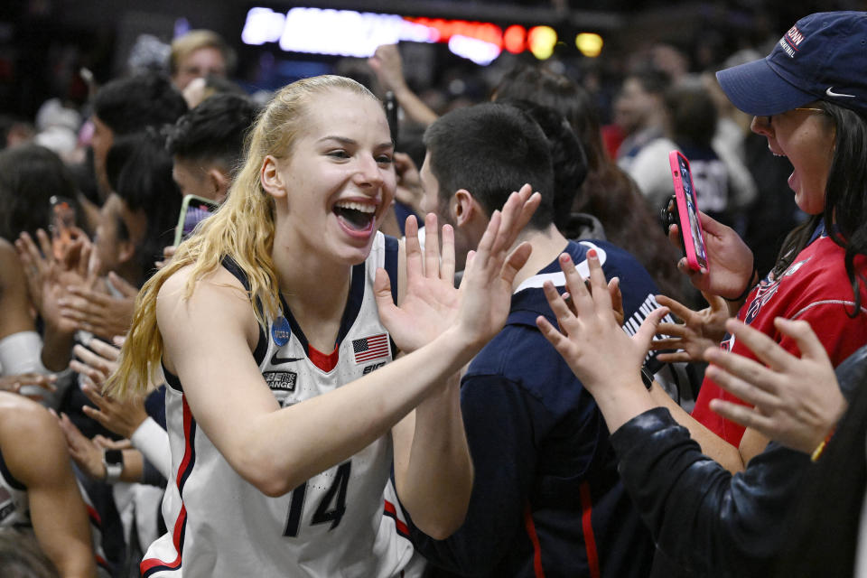 UConn's Dorka Juhasz (14) celebrates her team's win in a second-round college basketball game against Baylor in the NCAA Tournamen in Storrs, Conn., March 20, 2023. March Madness may have been the last time for fans to see many of the talented college women players compete. Players' options for professional basketball careers are limited, whether in the U.S. or overseas — the jobs just aren't there. (AP Photo/Jessica Hill)