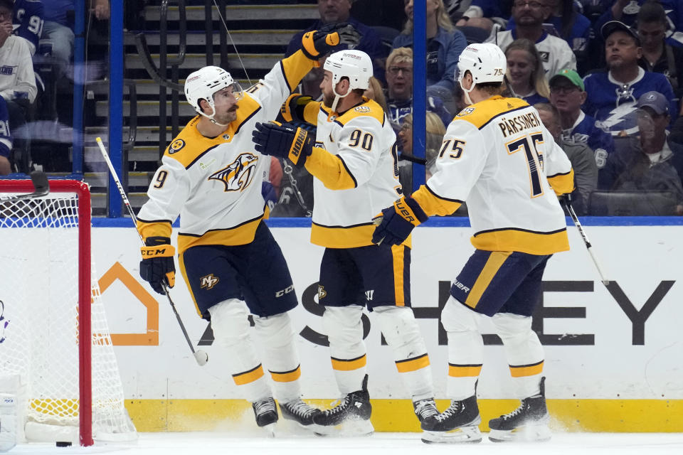 Nashville Predators center Ryan O'Reilly (90) celebrates his goal against the Tampa Bay Lightning with left wing Filip Forsberg (9) and center Juuso Parssinen (75) during the second period of an NHL hockey game Tuesday, Oct. 10, 2023, in Tampa, Fla. (AP Photo/Chris O'Meara)