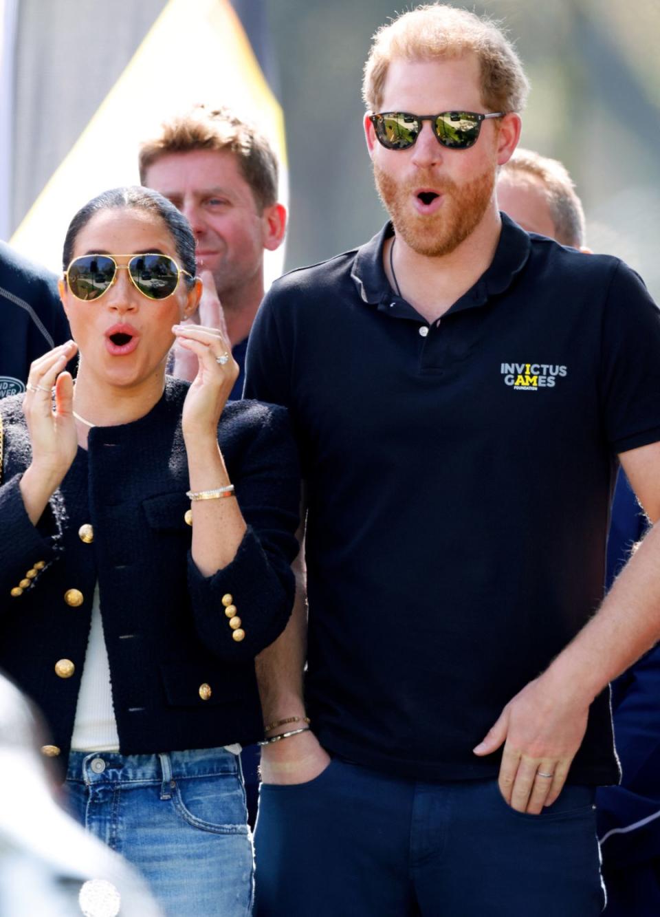 Prince Harry and Meghan reacting to a car race