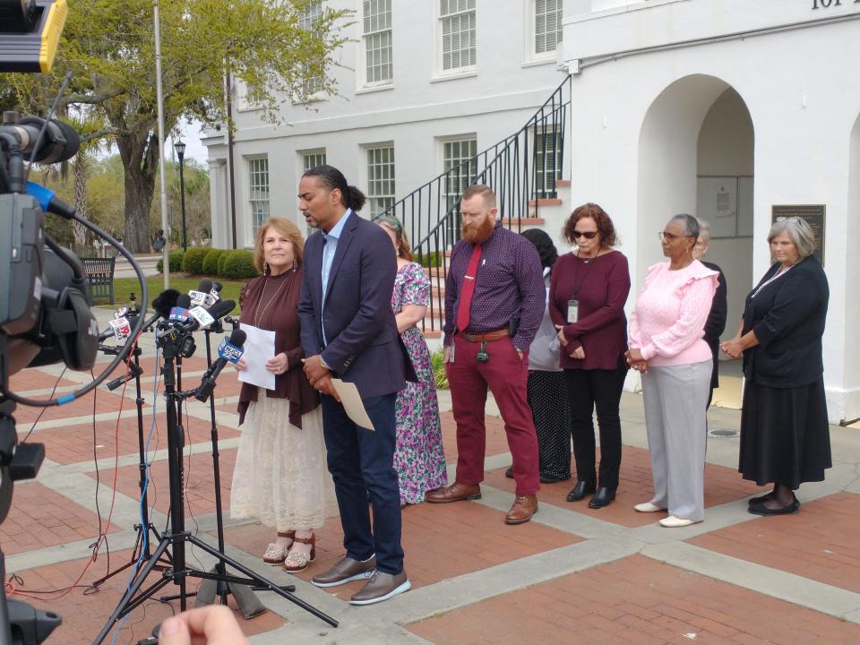 With her staff behind her and her attorney Justin Bamberg at her side, embattled Colleton County Clerk of Court Rebecca Hill, at far left, resigned from office Monday.