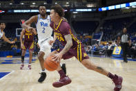 Minnesota's Sean Sutherlin (24) drives past Pittsburgh's Femi Odukale (2) during the first half of an NCAA college basketball game Tuesday, Nov. 30, 2021, in Pittsburgh. (AP Photo/Keith Srakocic)
