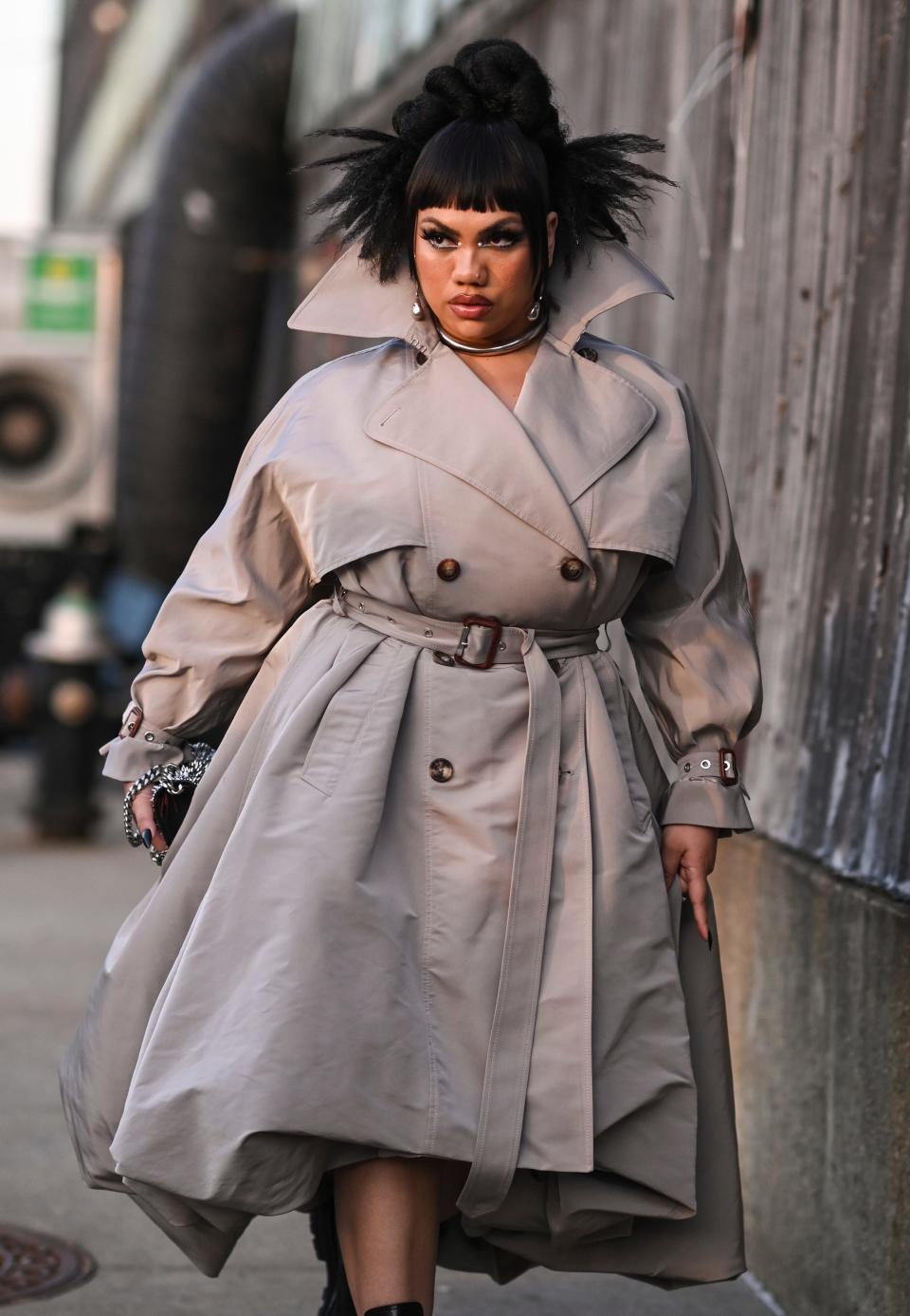 Parris Goebel is seen wearing a tan belted trench coat and black Alexander McQueen boots outside the Alexander McQueen AW22 show on March 15, 2022 in the borough of Brooklyn, New York