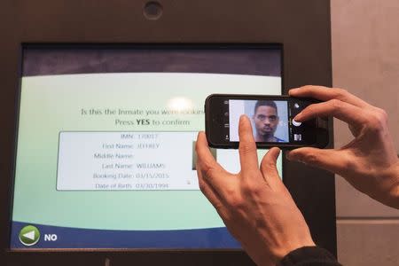 An image of Jeffrey Williams is shown onscreen of a kiosk at the St. Louis County Justice Center, in Clayton, Missouri, March 15, 2015. REUTERS/Kate Munsch