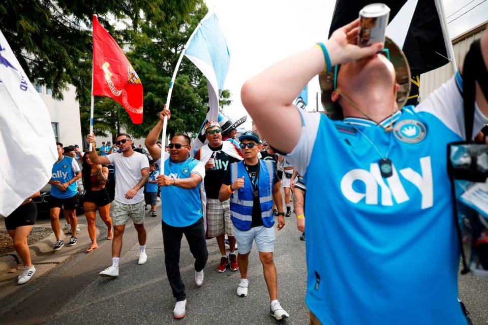 Charlotte FC fans march along East Cedar Street on their way to the match between Charlotte FC and Columbus Crew at Bank of America Stadium in Charlotte, N.C., Saturday, July 30, 2022.